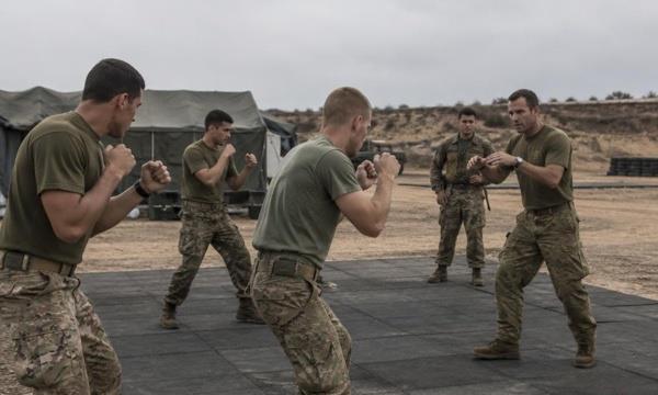 Military instructor guiding a martial arts training session
